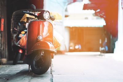 Close-up of motor scooter on street