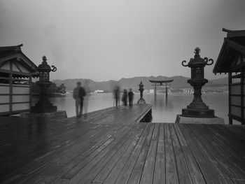 Group of people by japanese shrine at dawn