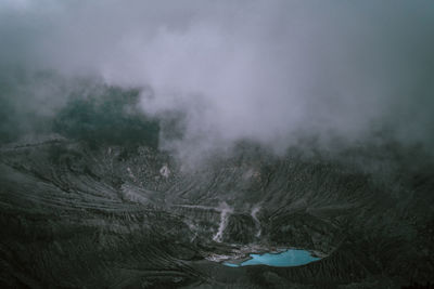 An active volcano from above with smoke