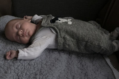 Cute baby boy sleeping on bed