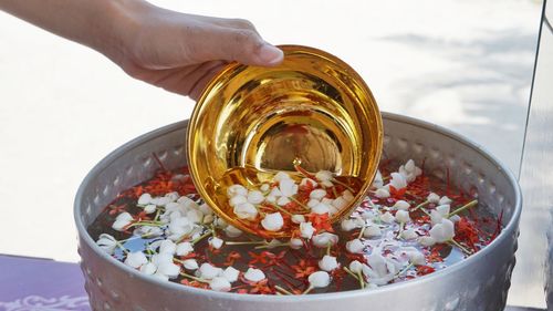 Close-up of hand holding glass bowl