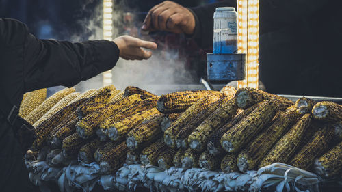 Man preparing food for sale at market stall