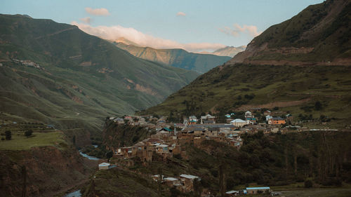 High angle view of houses amidst buildings against sky