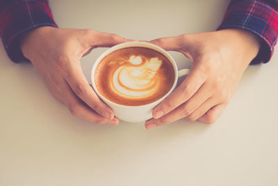 Midsection of woman holding coffee cup