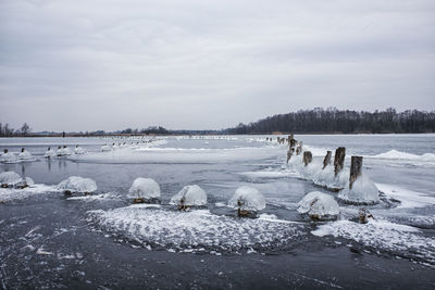 Scenic view of frozen lake against sky during winter