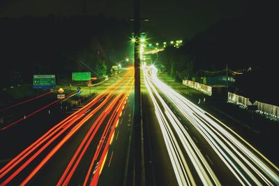 High angle view of light trails on highway at night