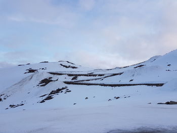 Scenic view of snow covered mountain against sky