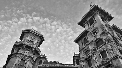 Low angle view of building against cloudy sky