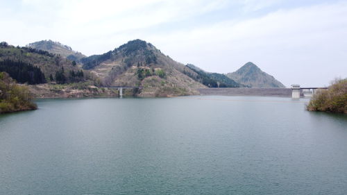 Scenic view of lake and mountains against sky