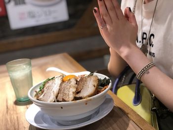 Midsection of woman preparing food on table