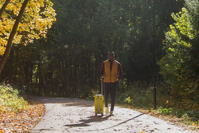 Rear view of woman standing in park