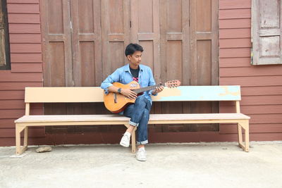 Full length of man playing guitar