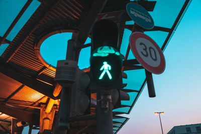 Low angle view of road sign against sky