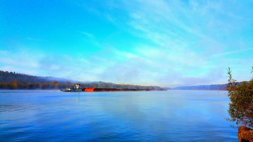 Scenic view of calm sea against cloudy sky