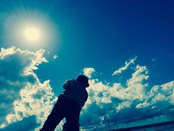 Low angle view of silhouette people against cloudy sky