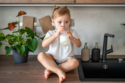 Portrait of cute girl playing with toy at home