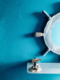 Close-up of electric light on table against blue background