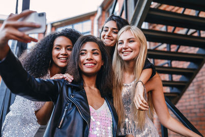 Portrait of smiling young woman using mobile phone