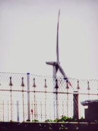 Low angle view of fence against sky