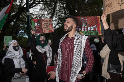 People standing against graffiti wall