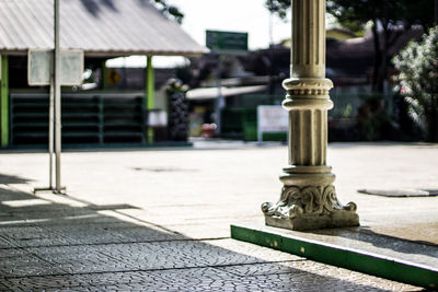 Close-up of cross on sidewalk by street