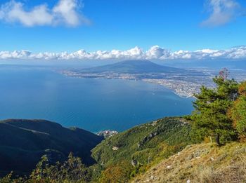 Scenic view of sea and mountains against sky