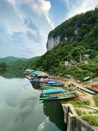 Boats moored in lake against sky