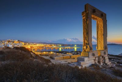 View of portara and remains of temple of apollo at sunset.