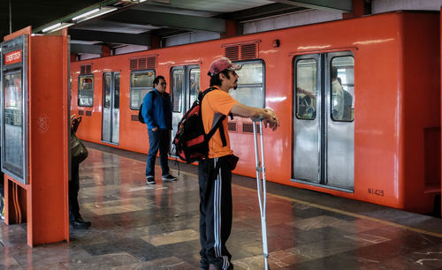 Woman standing on railroad station platform