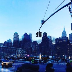 View of city during winter against blue sky