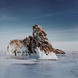 Frozen sea against sky during winter