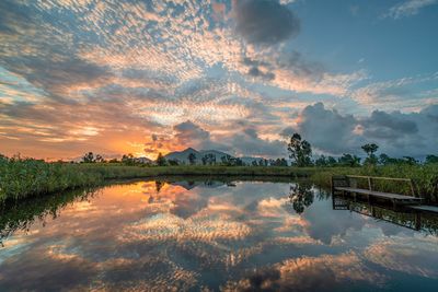 Scenic view of morning sunrise against sky in wetland pool / lake, hong kong