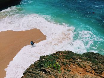 High angle view of man sitting at beach