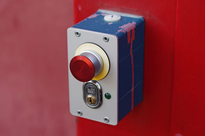 Red button and lock in a metal box to open a garage door