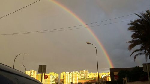 Low angle view of rainbow over city