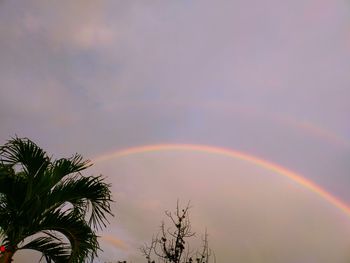 Low angle view of rainbow against sky at sunset