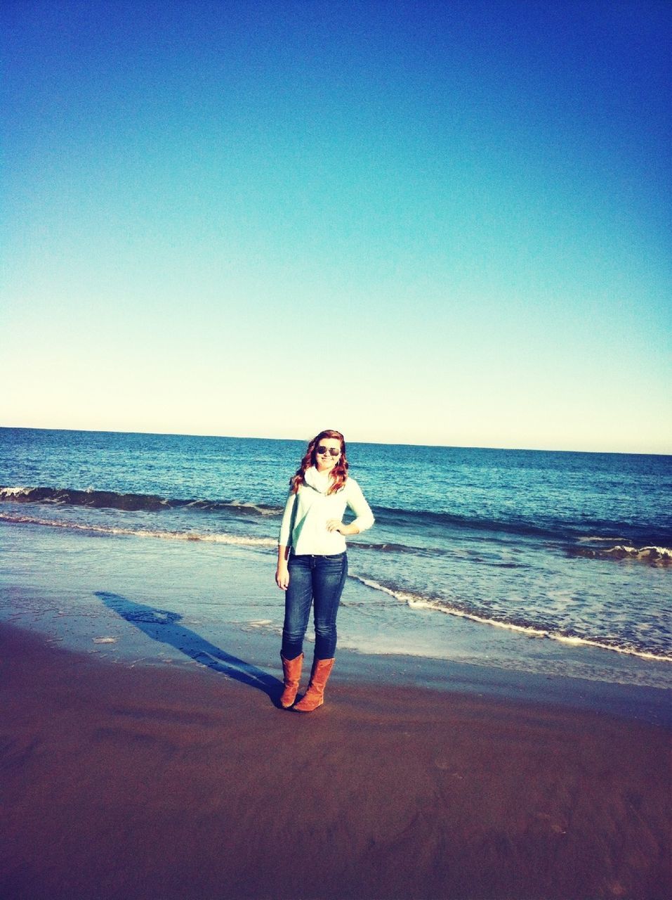 sea, beach, horizon over water, water, clear sky, shore, copy space, full length, leisure activity, lifestyles, sand, standing, casual clothing, young adult, blue, vacations, person, beauty in nature