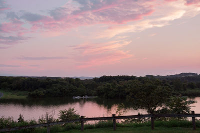 Scenic view of lake against sky at sunset