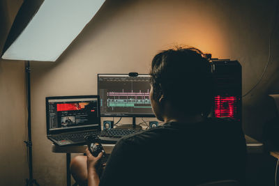 Rear view of man using mobile phone