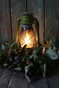 Close-up of illuminated lantern on table