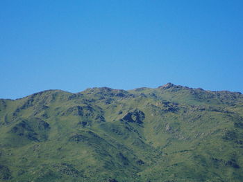 Scenic view of mountains against clear blue sky