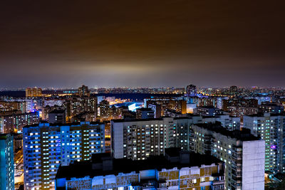 High angle view of illuminated buildings against sky at night