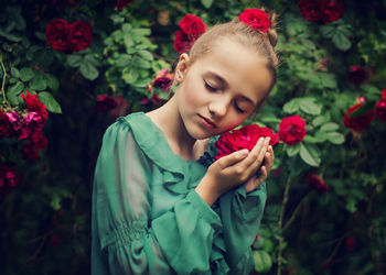 Portrait of beautiful woman with red flower