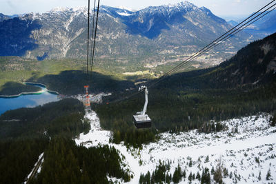 Scenic view of lake by mountains during winter