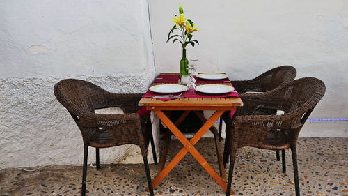 Empty chair and table against wall at home