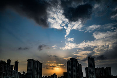 Low angle view of buildings against sky during sunset