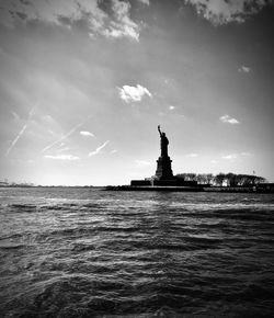 Statue of liberty against cloudy sky