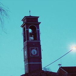 Low angle view of clock tower against clear blue sky