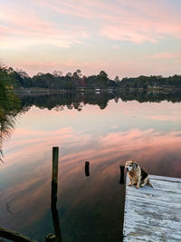 Scenic view of lake against sky at sunset