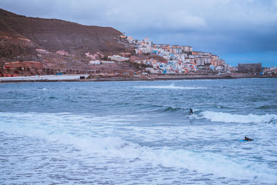 Surfer riding a board on the waves of the ocean